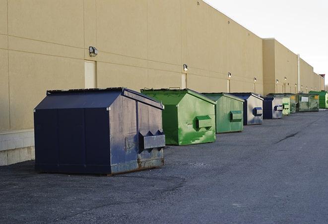 a row of industrial dumpsters at a construction site in Amawalk